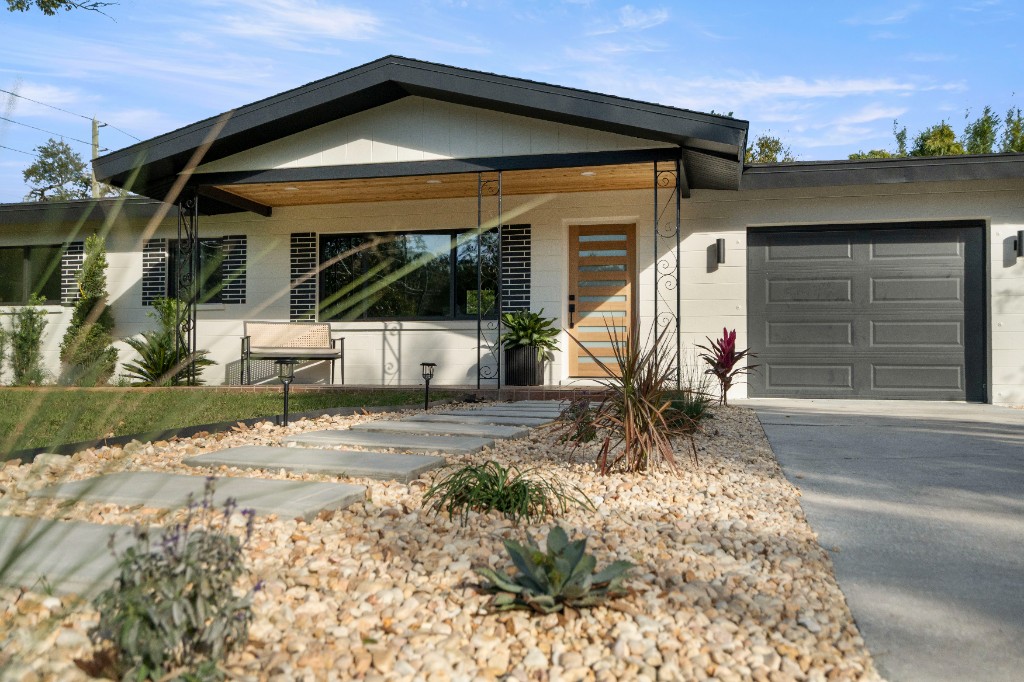 Renovated mid-century modern home exterior with landscaping in Tampa Bay